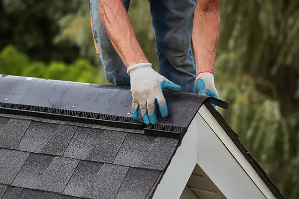 Roofer installing GAF ventilation product