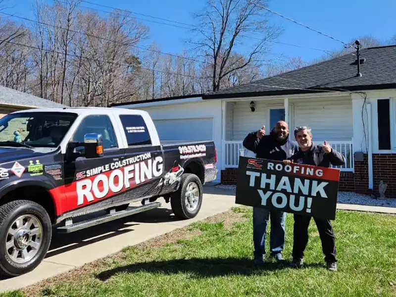 Simple Construction with a happy client holding up a Thank You! sign