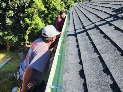 White, k-style gutter system with a downspout