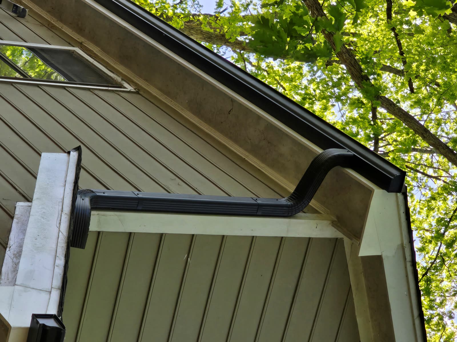 New black seamless gutters and downspout installed Raleigh NC