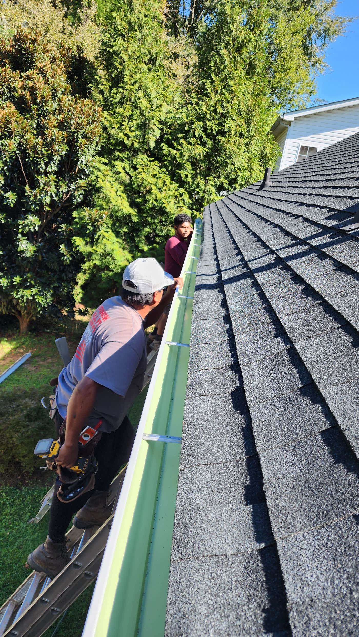 Simple Construction Roofing crew installing gutters Raleigh NC