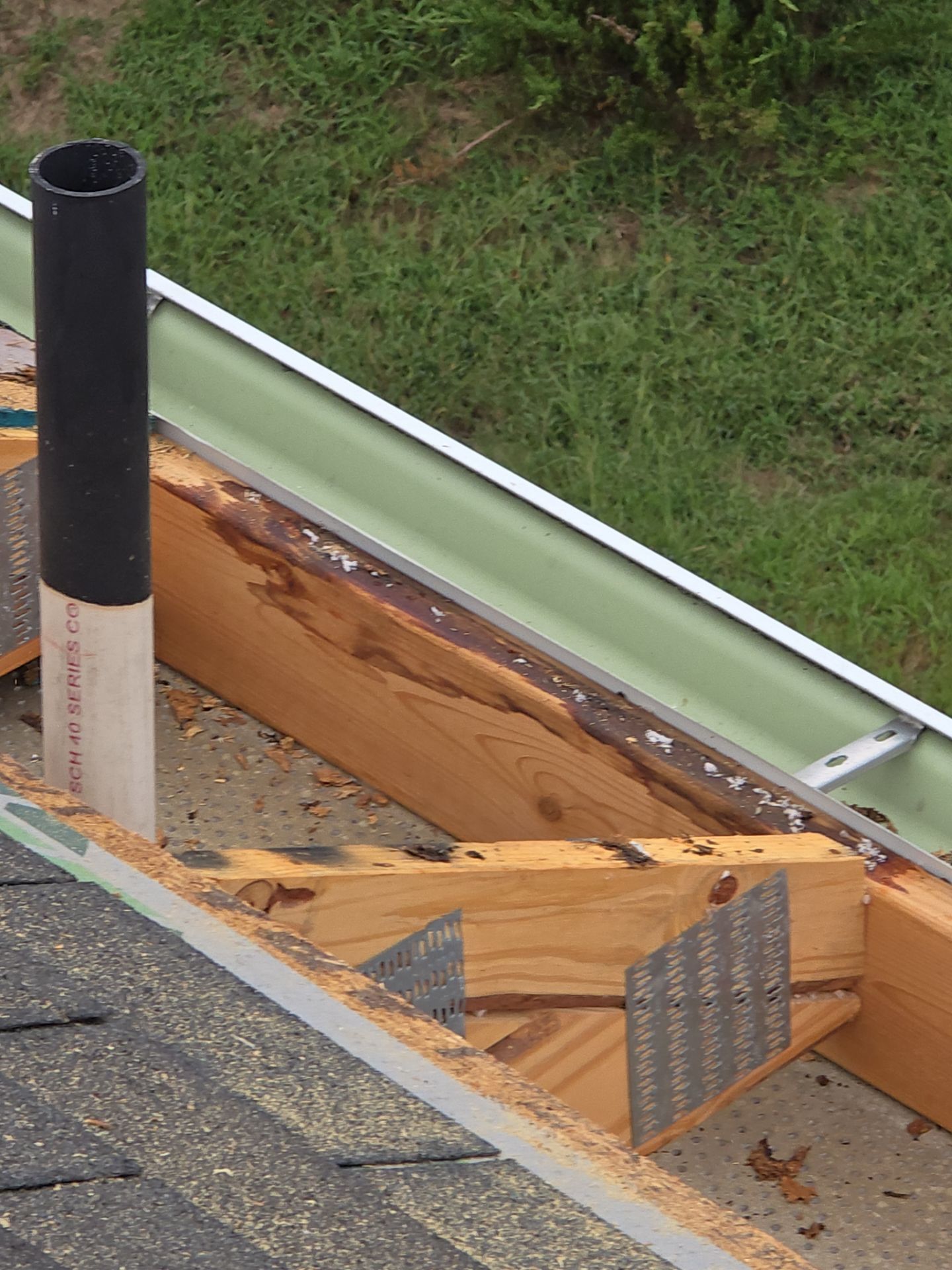 Exposed roof framing around hole before emergency repair Raleigh NC
