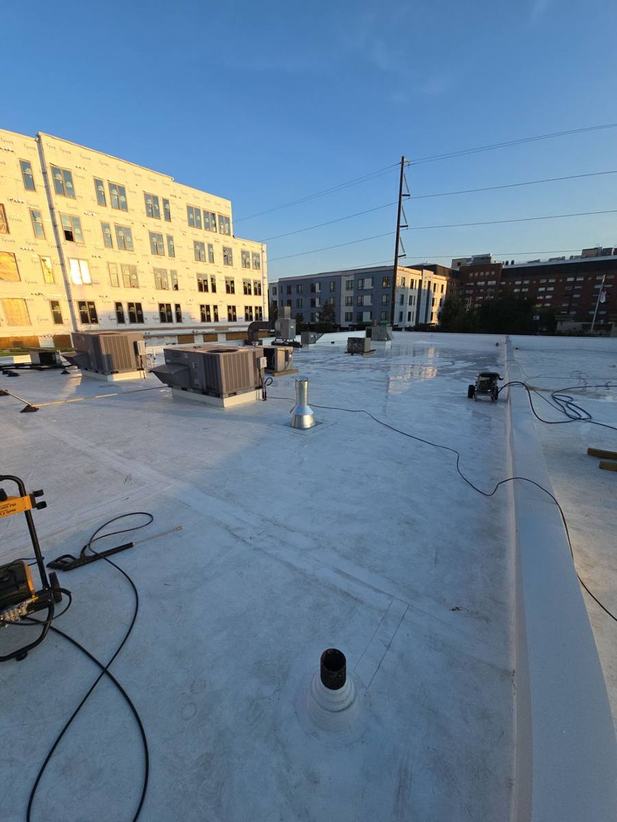 Simple Construction Roofing crew installing a flat roof in Raleigh, NC
