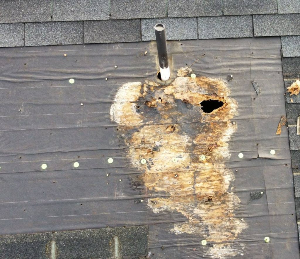 Severe deck rot around plumbing vent pipe - before pipe boot repair Raleigh NC