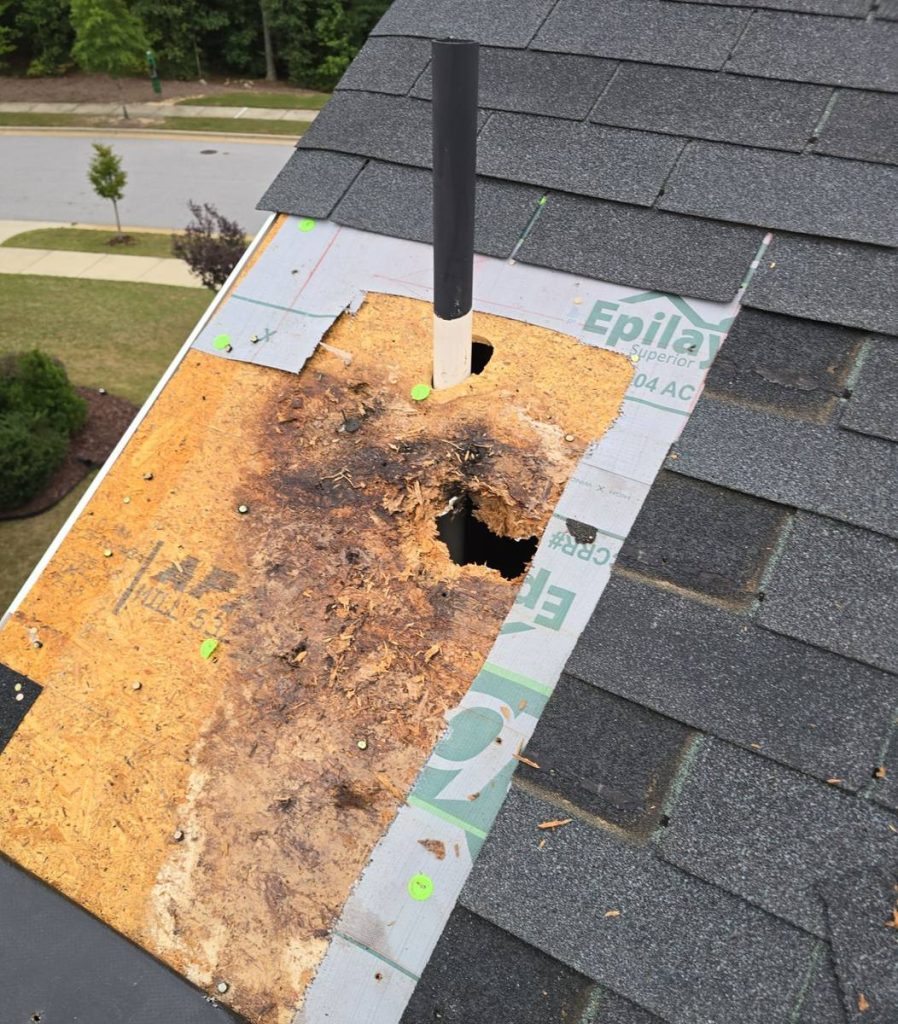Rotted roof decking around vent pipe from failed pipe boot in Raleigh NC - before repair