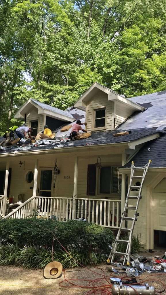 Roofing crew installing new shingles on Raleigh NC home